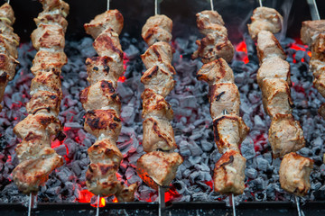 Pork shish kebab on skewers grilled on charcoal on the grill.