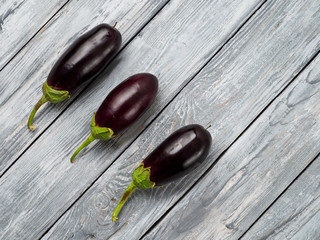 Fresh aubergines on wooden rustic background.