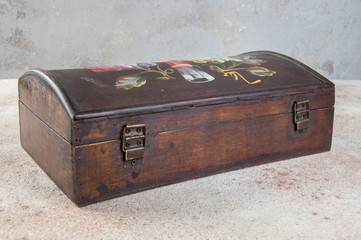 Old wooden box on concrete background.