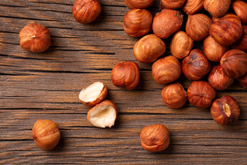 Heap of peeled hazelnuts close-up. Peeled hazelnuts on a wooden background.