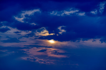 Fototapeta na wymiar clouds againts a dramatic sky at sunset