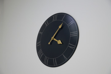 authentic black clock on a white wall.  interior
