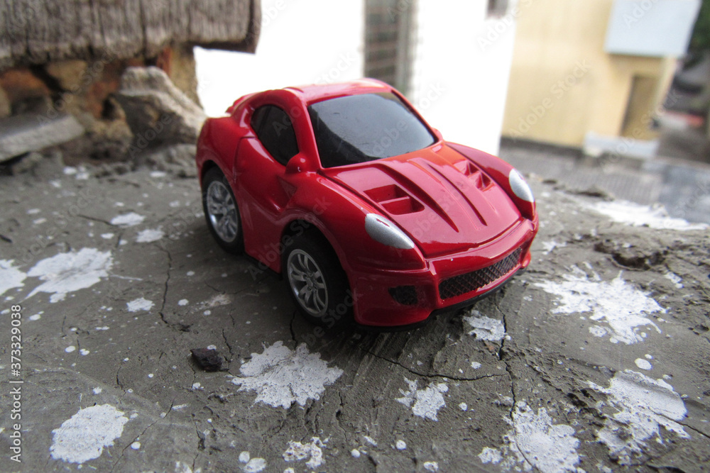 Canvas Prints Closeup shot of red color car toy on the street