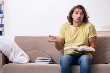 Fototapeta premium Young male student preparing for exams at home