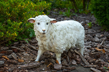 Porcelain sculpture of a sheep in the garden