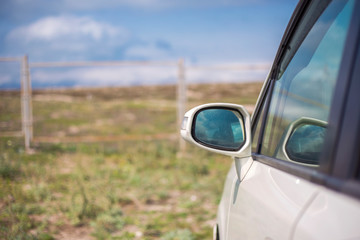 a white car mirror in the field
