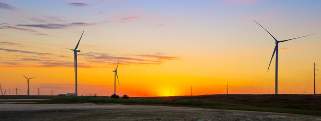 Wind generators of ecological power plant at sunset