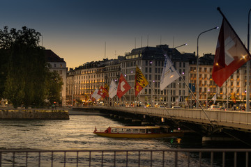 Pont du mont Blanc in the Rhône river, boat and flags
