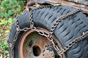 Chained tire on old tow truck.