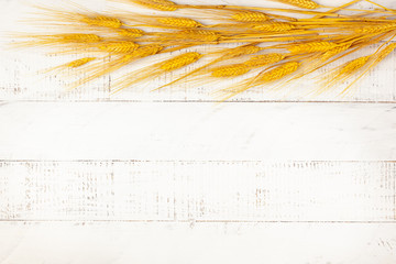  Concept of fall harvest. Autumn composition with wheat ears on white wooden table. Flat lay, copy...