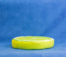 soft pillow in the form of a lemon on a blue background