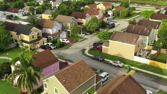 Flying over neighborhood tilt down reveal small backyards