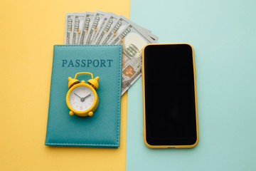 Travel planning with smartphone and passport with money.