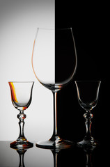 Three glass goblets on black and white background