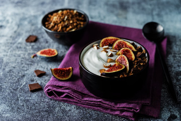 Greek yogurt chocolate almond nuts oatmeal granola with figs in a bowl
