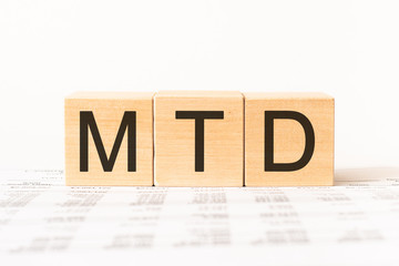 Word MTD - Month To Date acronym. Wooden small cubes with letters isolated on white background with copy space available. Business Concept image.