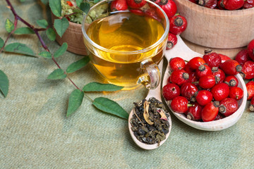 Dog rose, bunch branch Rosehips, types Rosa canina hips and herbal tea - Medicinal plants herbs...