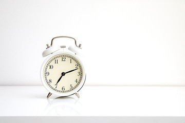 White alarm clock photography on white background