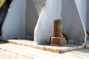 Close up view of the rusty anchor bolt in the structural steel.