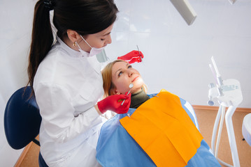 The dentist conducts an examination and consultation of the patient. Dentistry