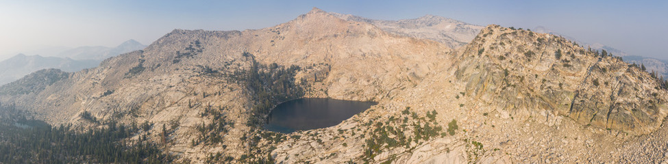 Fototapeta na wymiar A scenic lake is found amid the wilderness of the Sierra Nevada Mountains. Running along the eastern edge of California, the Sierra Nevadas are the major mountain range in western North America.