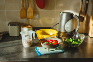 Various coloured organic vegetables washed in colander in kitchen