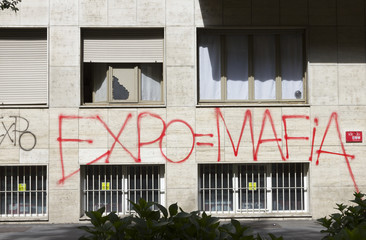 Fototapeta na wymiar Milan, Italy - May 2, 2015: Black Bloc graffiti against Expo exhibition, capitalism and government.