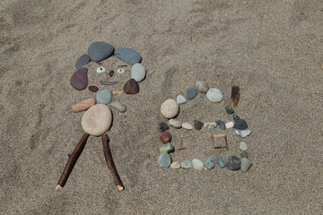 Making people with stones at the beach for children activity time.