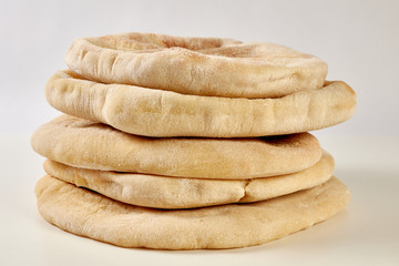 a pile of pita breads on a white background
