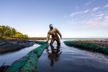 Volunteers clean the ocean coast from oil after a tanker wreck. Mauritius