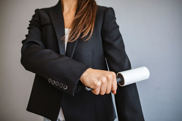 Cleaning the jacket with adhesive sticky roller. Domestic cleaning tool for getting rid of...