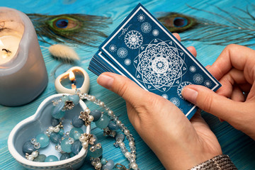 Fortune teller with a tarot cards in hands.