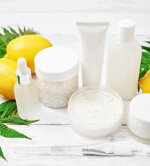Obraz na płótnie Canvas Natural organic homemade cosmetics with lemon. Skin care. Spa salon and treatments. Beautician background. Clay, lemon, beauty products.Tropical summer concept. Flat lay, copy space