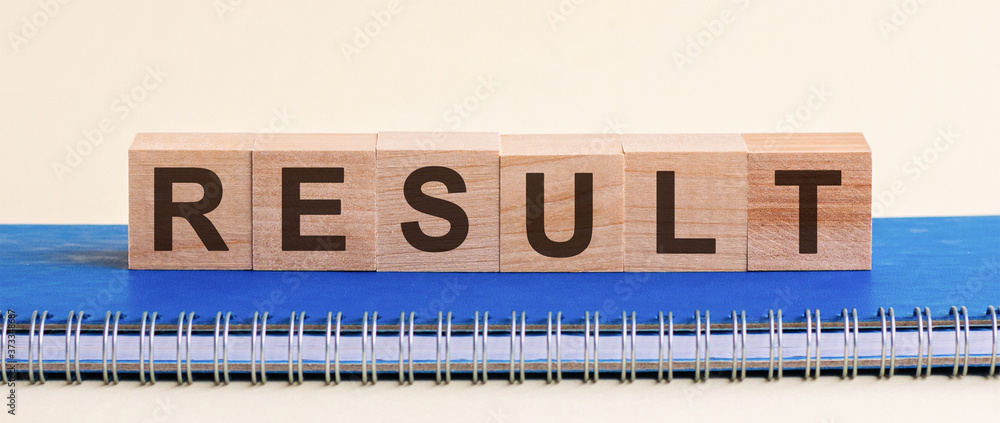 Poster result - a word made of wooden blocks with black letters, a row of blocks is located on a blue notep