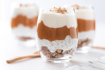 Yogurt with chia, peanut cream and nuts jars.