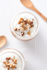 Yogurt with chia, peanut cream and nuts jars.