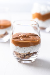 Yogurt with chia, peanut cream and nuts jars..