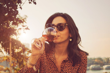 Beautiful elegant woman drinking wine.