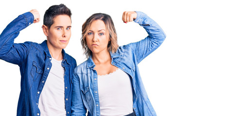Couple of women wearing casual clothes strong person showing arm muscle, confident and proud of power