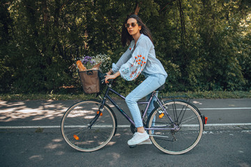 Attractive beautiful woman riding a bicycle in nature.