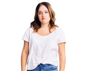 Fototapeta premium Young beautiful caucasian woman wearing casual white tshirt looking sleepy and tired, exhausted for fatigue and hangover, lazy eyes in the morning.