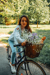 Fototapeta na wymiar Attractive beautiful woman riding a bicycle in nature.