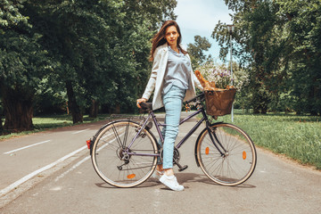 Business elegant woman riding a bicycle in nature.