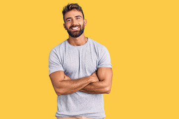 Young hispanic man wearing casual clothes happy face smiling with crossed arms looking at the camera. positive person.