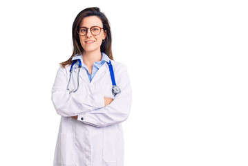 Fototapeta premium Young beautiful woman wearing doctor stethoscope and glasses happy face smiling with crossed arms looking at the camera. positive person.