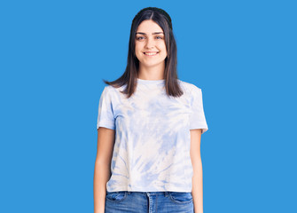 Young beautiful girl wearing casual t shirt with a happy and cool smile on face. lucky person.