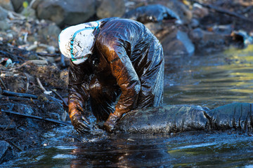 Volunteers clean the ocean coast from oil after a tanker wreck. Mauritius