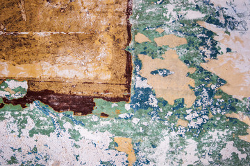 Textures and cracks on a wall in an old derelict building