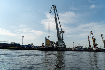 Fototapeta premium loading and unloading crane mounted on a small barge