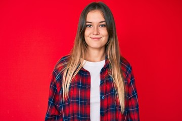 Beautiful caucasian woman wearing casual clothes looking positive and happy standing and smiling with a confident smile showing teeth